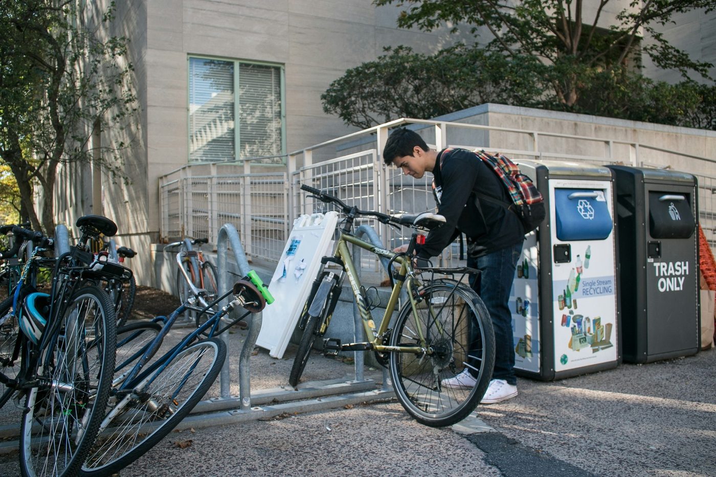 Commuter with backpack arriving at a bike rack area